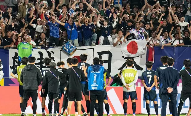 Japan players stand in front of their fans after losing a FIFA U-20 World Cup round of sixteen soccer match against France at National Stadium in Santiago, Chile, Wednesday, Oct. 8, 2025. (AP Photo/Matias Delacroix)