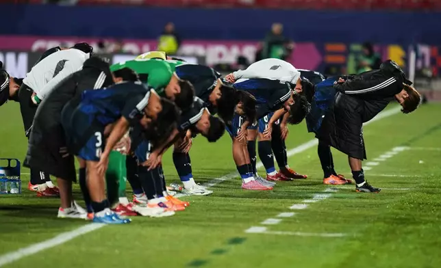 Japan players bow afer losing a FIFA U-20 World Cup round of sixteen soccer match against France at National Stadium in Santiago, Chile, Wednesday, Oct. 8, 2025. (AP Photo/Esteban Felix)