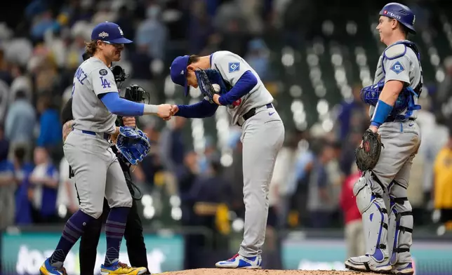 Los Angeles Dodgers pitcher Yoshinobu Yamamoto celebrates throwing a complete game against the Milwaukee Brewers, in Game 2 of baseball's National League Championship Series, Tuesday, Oct. 14, 2025, in Milwaukee. (AP Photo/Ashley Landis)