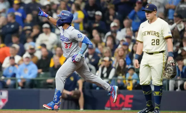 Los Angeles Dodgers' Teoscar Hernández celebrates his home run against the Milwaukee Brewers during the second inning in Game 2 of baseball's National League Championship Series, Tuesday, Oct. 14, 2025, in Milwaukee. (AP Photo/Ashley Landis)