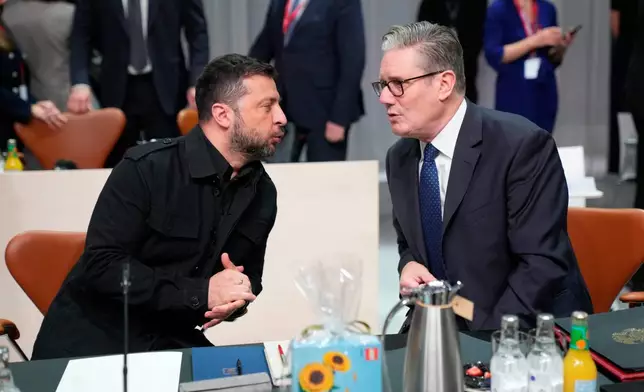 Britain's Prime Minister Kier Starmer, right, talks to Ukraine's President Volodymyr Zelenskyy, left , prior to a meeting of the European Political Community (EPC) in Copenhagen, Denmark, Thursday, Oct. 2, 2025. (Ida Marie Odgaard/Ritzau Scanpix via AP)
