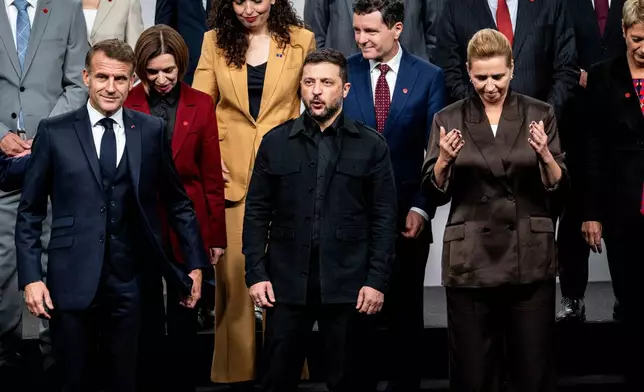 Front from left, France's President Emmanuel Macron, Ukraine's President Volodymyr Zelenskyy and Danish Prime Minister Mette Frederiksen leave after a family photo during a meeting of the European Political Community (EPC) in Copenhagen, Denmark, Thursday, Oct. 2, 2025. (Ida Marie Odgaard/Ritzau Scanpix via AP)