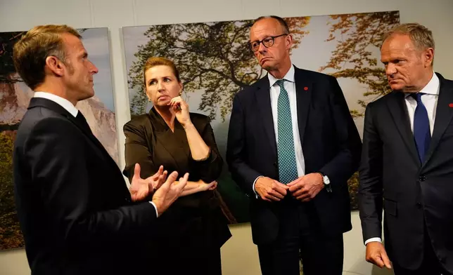 From left, France's President Emmanuel Macron, Danish Prime Minister Mette Frederiksen, German Chancellor Friedrich Merz and Poland's Prime Minister Donald Tusk talk during a meeting of the European Political Community (EPC) in Copenhagen, Denmark, Thursday, Oct. 2, 2025. (Mads Claus Rasmussen/Ritzau Scanpix via AP)