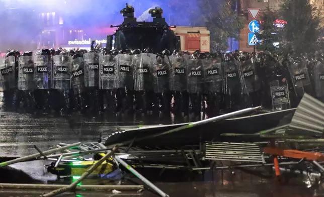 Police block a street to prevent demonstrators from advancing during an opposition rally in the city center of Tbilisi, Georgia, on Saturday, Oct. 4, 2025, as they boycott the municipal elections and call for the release of political opponents. (AP Photo/Zurab Tsertsvadze)