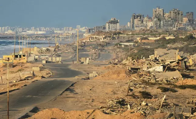 Israeli tanks are positioned on the coastal road leading to Gaza City near Wadi Gaza, in the central Gaza Strip, Thursday, Oct. 9, 2025. (AP Photo/Abdel Kareem Hana)