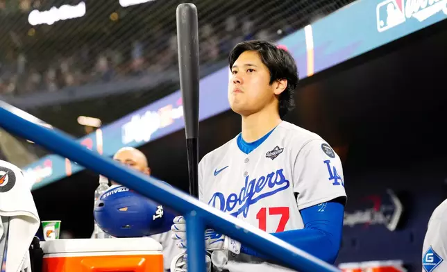 Los Angeles Dodgers' Shohei Ohtani (17) waits in the dugout ahead of the top of the seventh inning of Game 1 of baseball's World Series against the Toronto Blue Jays in Toronto, Friday, Oct. 24, 2025. (Frank Gunn/The Canadian Press via AP)