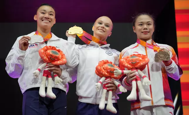 Medalists Leanne Wong of United States with silver, left, Individual Neutral Athlete Angelina Melnikova with gold, center, and Zhang Qingying of China, with bronze, right, after the Women's All-Around Final during the 53rd Artistic Gymnastics World Championships in Jakarta, Indonesia, Thursday, Oct. 23, 2025. (AP Photo/Dita Alangkara)