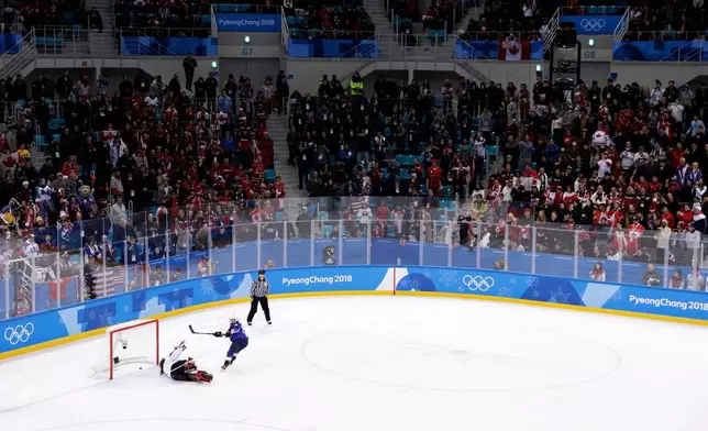 FILE - Jocelyne Lamoureux-Davidson (17), of the United States, scores the winning shot during a shootout against goalie Shannon Szabados (1), of Canada, in the women's gold medal hockey game at the 2018 Winter Olympics in Gangneung, South Korea, Feb. 22, 2018. (AP Photo/Matt Slocum, File)