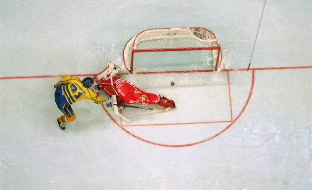 FILE - Sweden's Peter Forsberg flips the puck past Canadian goalkeeper Corey Hirsch, scoring the game winning shootout goal in their gold medal game of the Olympics in Lillehammer, February 27, 1994. (AP Photo/Al Behrman, File)