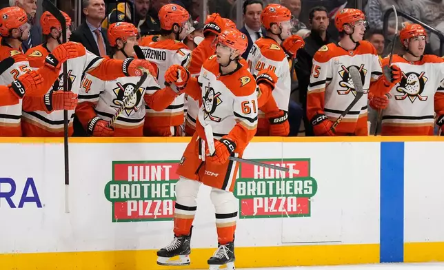 Anaheim Ducks left wing Cutter Gauthier (61) celebrates his goal with teammates during the second period of an NHL hockey game against the Nashville Predators, Tuesday, Oct. 21, 2025, in Nashville, Tenn. (AP Photo/George Walker IV)