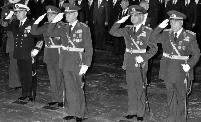 FILE - Gen. Kenan Evren, center, stands with the other leaders of the Sept. 12 military coup during a ceremony at the mausoleum of the founder of modern Turkey, Kemal Ataturk, in Ankara, Turkey, Oct. 29, 1980. (AP Photo/Burhan Ozbilici, File)