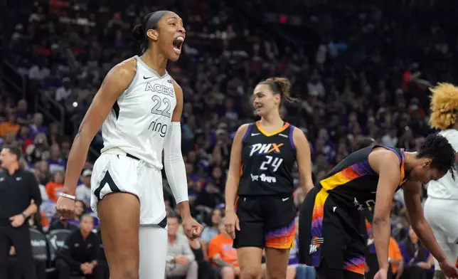 Las Vegas Aces center A'ja Wilson (22) reacts after scoring against the Phoenix Mercury during the first half of Game 4 of the WNBA basketball finals, Friday, Oct. 10, 2025, in Phoenix. (AP Photo/Rick Scuteri)