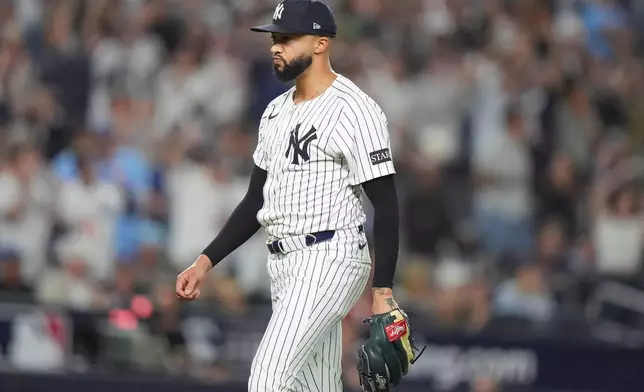 New York Yankees pitcher Devin Williams prepares for the next batter during the seventh inning of Game 3 of baseball's American League Division Series against the Toronto Blue Jays, Tuesday, Oct. 7, 2025, in New York. (AP Photo/Frank Franklin II)