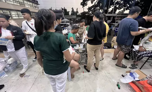 Patients wait outside the Cebu Provincial Hospital Bogo City after a strong earthquake struck in Bogo city, Cebu province, central Philippines on Wednesday, Oct. 1, 2025. (AP Photo)