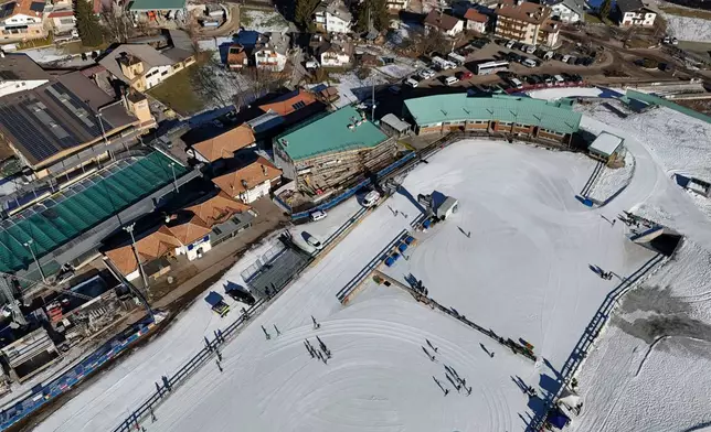 FILE - Skiers are seen from above at the Cross Country skiing stadium which will be used at the Milan Cortina 2026 Winter Olympics, in Tesero, Italy, Friday, Jan. 17, 2025. (AP Photo/Luca Bruno, File)