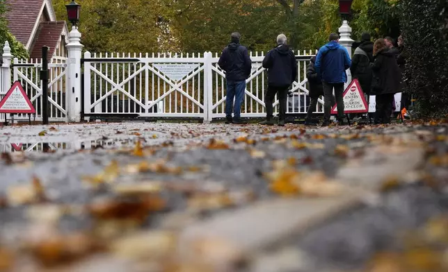 Journalists wait at an entrance near to the Royal Lodge, following the announcement that Prince Andrew will be stripped of his titles and leave the 30-room mansion he has occupied for more than 20 years in Windsor, England, Friday, Oct. 31, 2025.(AP Photo/Alastair Grant)