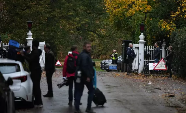 Journalists wait at an entrance near to the Royal Lodge, following the announcement that Prince Andrew will be stripped of his titles and leave the 30-room mansion he has occupied for more than 20 years in Windsor, England, Friday, Oct. 31, 2025.(AP Photo/Alastair Grant)