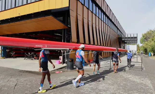 South African rowers carry their boat after practice Wednesday, Oct. 15, 2025, in Boston. (AP Photo/Leah Willingham)