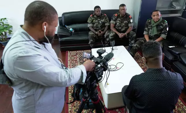 CAPSAT military unit commander Col. Michael Randrianirina, right, speaks during an interview with the Associated Press at the CAPSAT military barracks in Antananarivo, Madagascar, Wednesday, Oct. 15, 2025. (AP Photo/Brian Inganga)