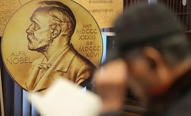 FILE - A visitor reads a book written by South Korean author Han Kang, this year's winner of the Nobel Prize in Literature, at a special section of a bookstore in Seoul, South Korea, Tuesday, Dec. 10, 2024. (AP Photo/Lee Jin-man, File)