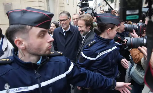 French socialist party secretary general Olivier Faure, center left, and Boris Vallaud, center right, president of the socialist parliament members at the National Assembly, arrive for a meeting with outgoing Prime Minister Sebastien Lecornu, Wednesday, Oct. 8, 2025 in Paris. (AP Photo/Christophe Ena)