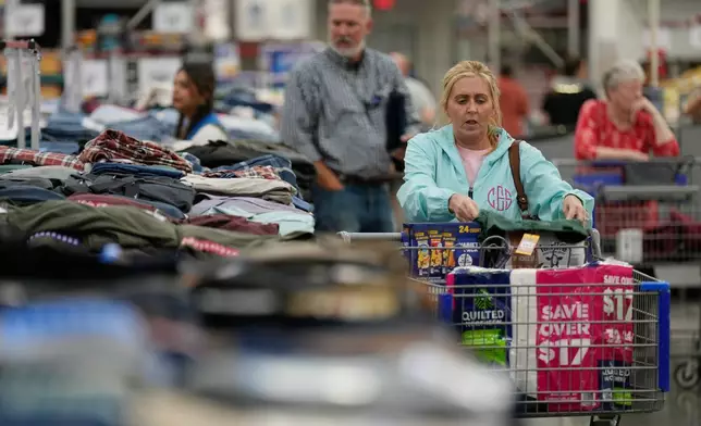 People shop for clothing at a Sam's Club, Wednesday, Sept. 24, 2025, in Bentonville, Ark. (AP Photo/Charlie Riedel)