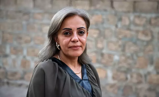 Kurdish health worker Dr. Rankin Abdow poses for a photo after winning a seat for the Afrin region in Syria's parliamentary election, in Aleppo, Syria, Sunday, Oct. 5, 2025. (AP Photo/Omar Albam)