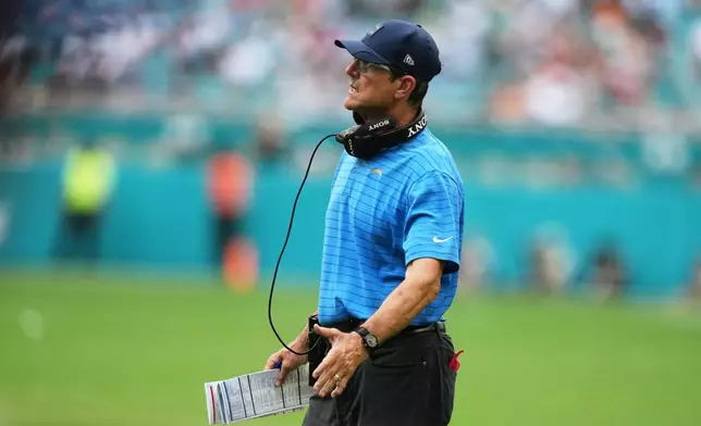 Los Angeles Chargers head coach Jim Harbaugh looks on during the first half of an NFL football game against the Miami Dolphins Sunday, Oct. 12, 2025, in Miami Gardens, Fla. (AP Photo/Lynne Sladky)