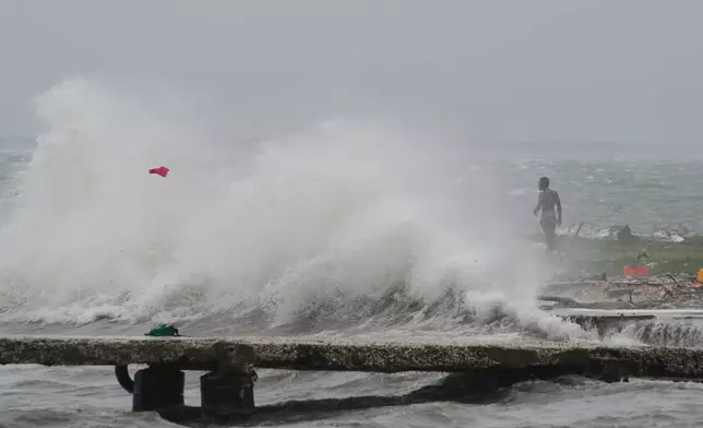 Waves splash in Kingston, Jamaica, as Hurricane Melissa approaches, Tuesday, Oct. 28, 2025. (AP Photo/Matias Delacroix)