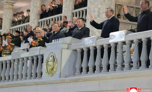 In this photo provided by North Korean government, North Korean leader Kim Jong Un, third right, Chinese Premier Li Qiang, fourth right, Vietnamese Communist Party General Secretary To Lam, second right, Russian Security Council Deputy Chairman Dmitry Medvedev, right, attend the military parade marking the 80th anniversary of the founding of the ruling Worker's Party, in Pyongyang, North Korea, Friday, Oct. 10, 2025. Independent journalists were not given access to cover the event depicted in this image distributed by the North Korean government. The content of this image is as provided and cannot be independently verified. Korean language watermark on image as provided by source reads: "KCNA" which is the abbreviation for Korean Central News Agency. (Korean Central News Agency/Korea News Service via AP)