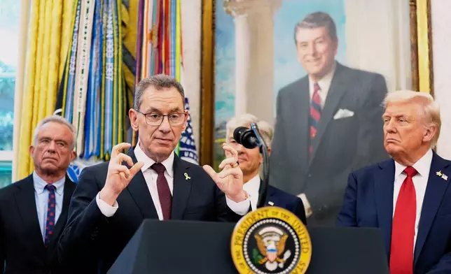 Albert Bourla, chairman and chief executive officer of the pharmaceutical company Pfizer. speaks in the Oval Office of the White House, Tuesday, Sept. 30, 2025, in Washington, as from left, Secretary of Health and Human Services Robert F. Kennedy, Jr., Mehmet Oz, Administrator for the Centers for Medicare &amp; Medicaid Services and President Donald Trump, right, look on. (AP Photo/Alex Brandon)