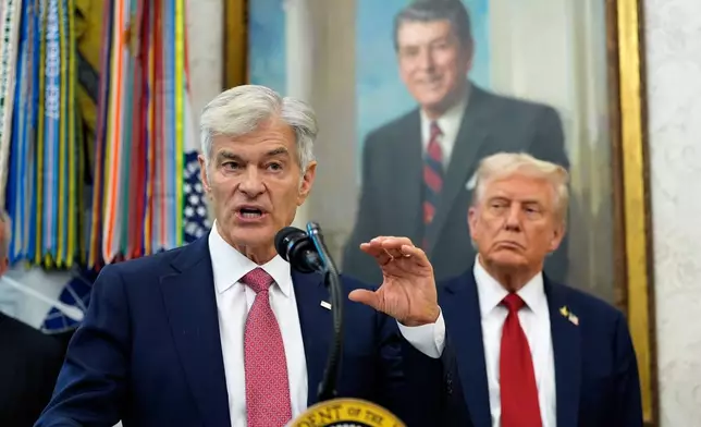Mehmet Oz, Administrator for the Centers for Medicare &amp; Medicaid Services speaks in the Oval Office of the White House, Tuesday, Sept. 30, 2025, in Washington, as President Donald Trump looks on. (AP Photo/Alex Brandon)