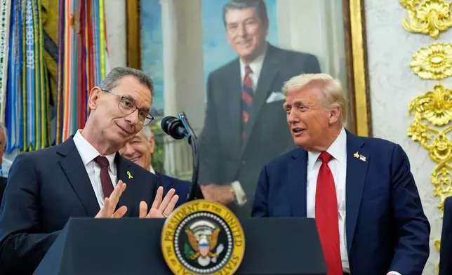 Albert Bourla, chairman and chief executive officer of the pharmaceutical company Pfizer. speaks in the Oval Office of the White House, Tuesday, Sept. 30, 2025, in Washington, as President Donald Trump, right, and Mehmet Oz, Administrator for the Centers for Medicare &amp; Medicaid Services, rear, look on. (AP Photo/Alex Brandon)