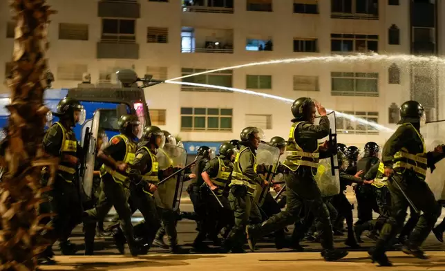 Security forces disperse a gathering as youth led protests calling for healthcare and education reforms turned violent, in Sale, Morocco, Wednesday, Oct. 1, 2025. (AP Photo/Mosa'ab Elshamy)