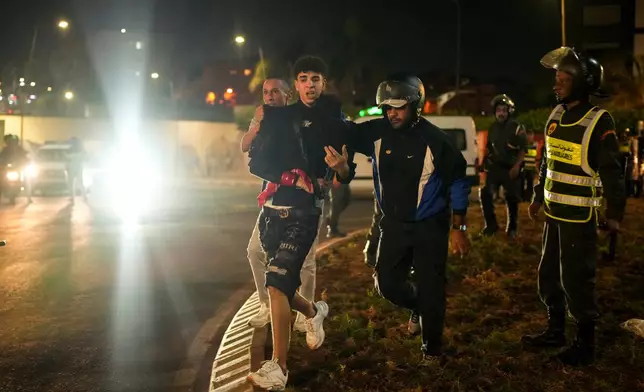 A boy is detained as youth led protests calling for healthcare and education reforms turned violent, in Sale, Morocco, Wednesday, Oct. 1, 2025. (AP Photo/Mosa'ab Elshamy)