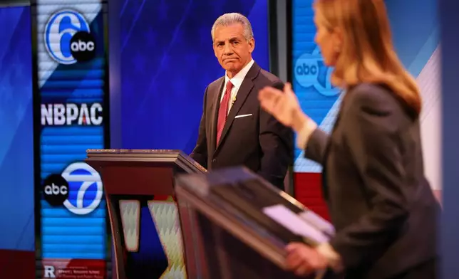Republican Jack Ciattarelli, left, looks on while Democrat Mikie Sherrill speaks during the final debate in the New Jersey governor's race, Wednesday, Oct. 8, 2025, in New Brunswick, N.J. (AP Photo/Heather Khalifa)