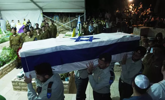 Israeli soldiers carry the coffin of slain hostage Captain Daniel Peretz during his funeral at Mt. Herzl military cemetery in Jerusalem, Wednesday, Oct. 15, 2025. Peretz's body was returned from Gaza to Israel as part of a ceasefire agreement between Israel and Hamas. (AP Photo/Francisco Seco)
