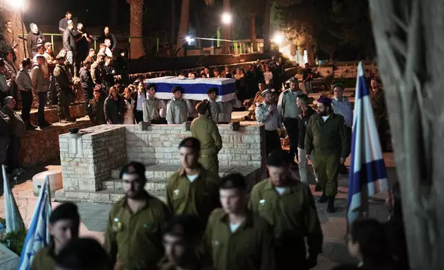 Israeli soldiers carry the coffin of slain hostage Captain Daniel Peretz during his funeral at Mt. Herzl military cemetery in Jerusalem, Wednesday, Oct. 15, 2025. Peretz's body was returned from Gaza to Israel as part of a ceasefire agreement between Israel and Hamas. (AP Photo/Francisco Seco)