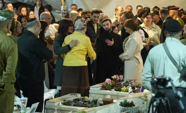 Freed hostage Matan Angrest attends the funeral of slain hostage Captain Daniel Peretz at Mt. Herzl military cemetery in Jerusalem, Wednesday, Oct. 15, 2025. (AP Photo/Francisco Seco)