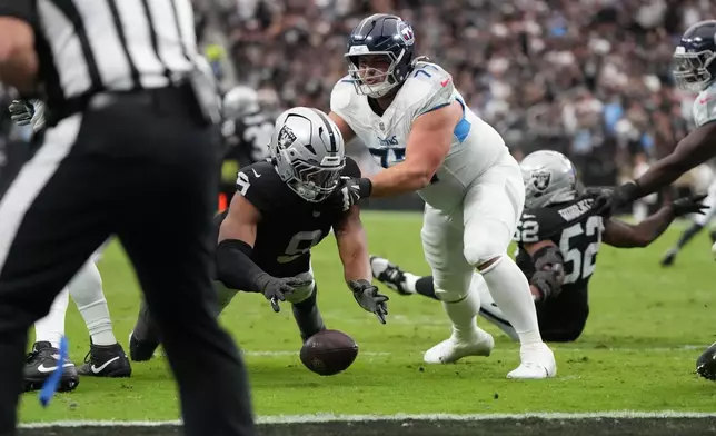 Las Vegas Raiders defensive end Tyree Wilson (9) recovers a fumble by the Tennessee Titans during the first half of an NFL football game, Sunday, Oct. 12, 2025, in Las Vegas. (AP Photo/Rick Scuteri)