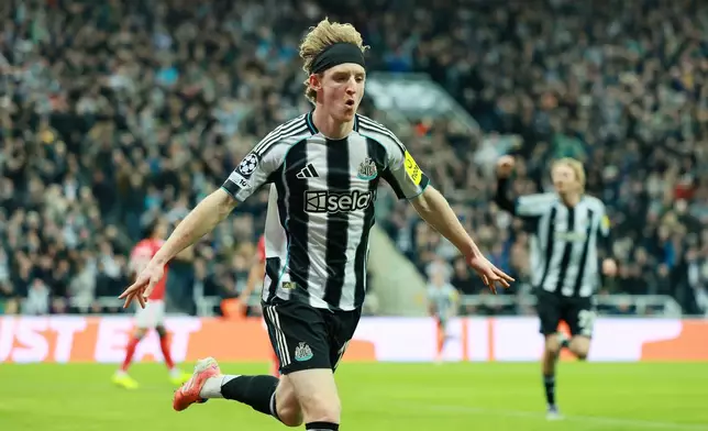 Newcastle United's Anthony Gordon celebrates after scoring their side's first goal of the game during the UEFA Champions League match between Benfica and Newcastle, in Newcastle-upon-Tyne, England, Tuesday Oct. 21, 2025. (Richard Sellers/PA via AP)