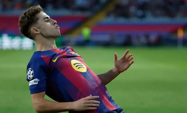 Barcelona's Fermin Lopez celebrates after scoring the opening goal of his team during the Champions League opening phase soccer match between Barcelona and Olympiacos in Barcelona, Spain, Tuesday, Oct. 21, 2025. (AP Photo/Joan Monfort)