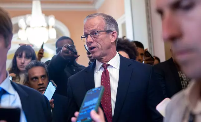 Senate Majority Leader John Thune, R-S.D., pauses in his office doorway to speak to reporters on day 20 of the government shutdown, at the Capitol in Washington, Monday, Oct. 20, 2025. (AP Photo/J. Scott Applewhite)