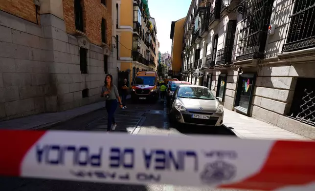Police tape is placed near the scene of a building collapse in Madrid, Spain, on Tuesday, Oct. 7, 2025. (AP Photo/Manu Fernandez)