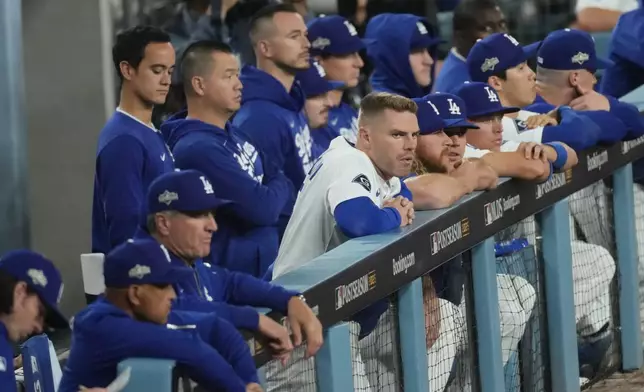 The Los Angeles Dodgers watch from the dugout during the ninth inning in Game 3 of baseball's National League Division Series against the Philadelphia Phillies, Wednesday, Oct. 8, 2025, in Los Angeles. (AP Photo/Jae C. Hong)