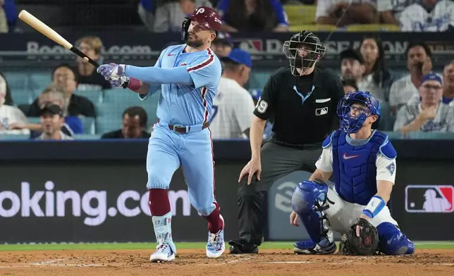 Philadelphia Phillies' Kyle Schwarber follows his solo home run off Los Angeles Dodgers starting pitcher Yoshinobu Yamamoto during the fourth inning in Game 3 of baseball's National League Division Series Wednesday, Oct. 8, 2025, in Los Angeles. (AP Photo/Jae C. Hong)