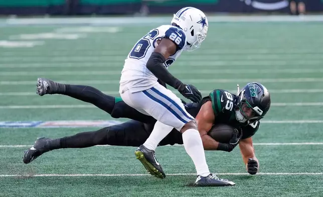 New York Jets' Mason Taylor catches a pass in front of Dallas Cowboys' Daron Bland during the second half of an NFL football game Sunday, Oct. 5, 2025, in East Rutherford, N.J. (AP Photo/Seth Wenig)