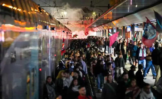 Pro-Palestinian demonstrators flood the rail track at Milan's Cadorna railway station, Italy, late Wednesday, Oct. 1, 2025, after news that a Gaza-bound aid flotilla had been intercepted by Israeli forces in the Mediterranean Sea. (AP Photo/Luca Bruno)