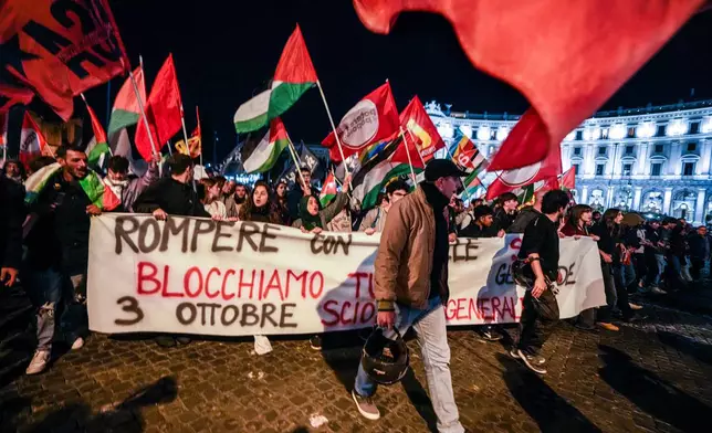 Pro-Palestinian activists march in downtown Rome late Wednesday, Oct. 1, 2025, after news that a Gaza-bound aid flotilla had been intercepted by Israeli forces in the Mediterranean Sea. (AP Photo/Andrew Medichini)