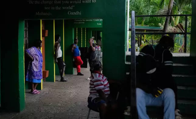People take shelter at a school ahead of Hurricane Melissa's forecast arrival in Old Harbour, Jamaica, Monday, Oct. 27, 2025. (AP Photo/Matias Delacroix)